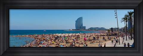 Framed Tourists on the beach with W Barcelona hotel in the background, Barceloneta Beach, Barcelona, Catalonia, Spain Print