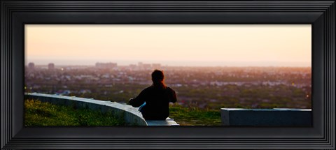 Framed Man sting on the ledge in Baldwin Hills Scenic Overlook Park, Culver City, Los Angeles County, California, USA Print