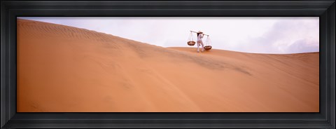 Framed Rear view of a woman carrying panniers, Mui Ne, Vietnam Print