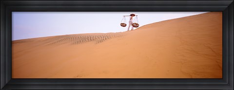 Framed Low angle view of a woman carrying panniers, Mui Ne, Vietnam Print