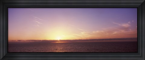 Framed Sun Setting Behind Clouds over the Sea Print