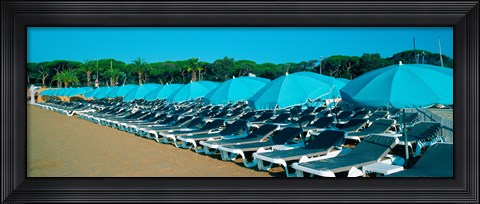 Framed Parasols with lounge chairs on a private beach in summer morning light, French Riviera, France Print