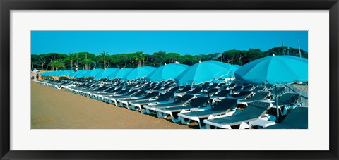 Framed Parasols with lounge chairs on a private beach in summer morning light, French Riviera, France Print