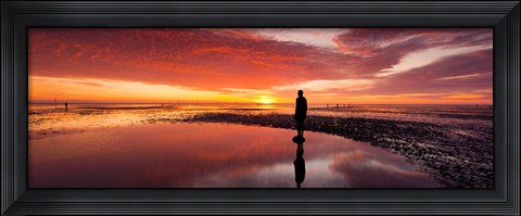 Framed Silhouette of human sculpture on the beach at sunset, Another Place, Crosby Beach, Merseyside, England Print