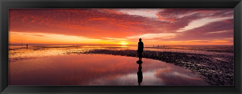 Framed Silhouette of human sculpture on the beach at sunset, Another Place, Crosby Beach, Merseyside, England Print