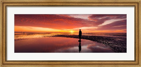 Framed Silhouette of human sculpture on the beach at sunset, Another Place, Crosby Beach, Merseyside, England Print