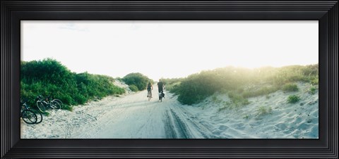 Framed Rear view of a couple cycling along a beach trail, Fort Tilden, Queens, New York City, New York State, USA Print