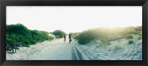 Framed Rear view of a couple cycling along a beach trail, Fort Tilden, Queens, New York City, New York State, USA Print