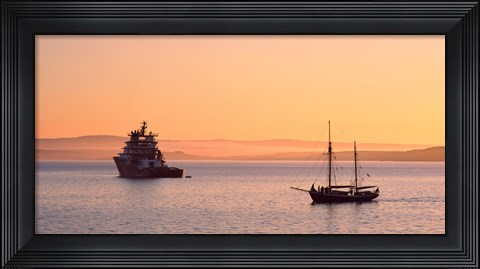 Framed Tugboat and a tall ship in the Baie de Douarnenez at sunrise, Finistere, Brittany, France Print