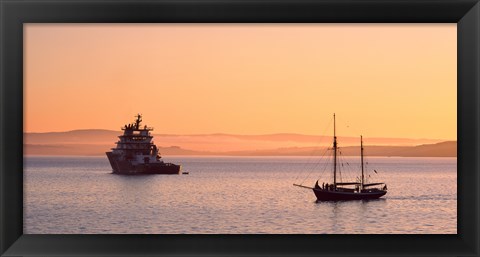 Framed Tugboat and a tall ship in the Baie de Douarnenez at sunrise, Finistere, Brittany, France Print