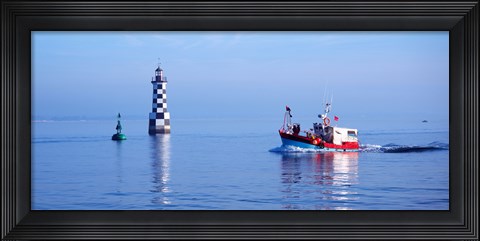 Framed Les Perdrix lighthouse and fishing boat at Loctudy, Brittany, France Print