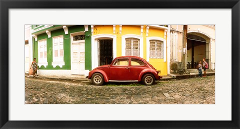 Framed Small old red car parked in front of colorful building, Pelourinho, Salvador, Bahia, Brazil Print