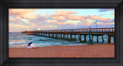 Framed Couple sitting on the beach at sunset, Fort Lauderdale, Florida, USA Print