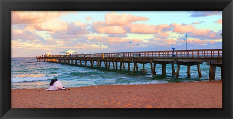 Framed Couple sitting on the beach at sunset, Fort Lauderdale, Florida, USA Print