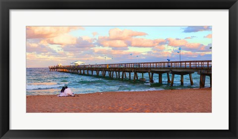 Framed Couple sitting on the beach at sunset, Fort Lauderdale, Florida, USA Print