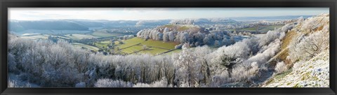 Framed Snow covered trees in a valley from Uley Bury, Downham Hill, Gloucestershire, England Print