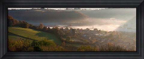 Framed Misty morning valley with village, Uley, Gloucestershire, England Print