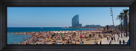 Framed Tourists on the beach with W Barcelona hotel in the background, Barceloneta Beach, Barcelona, Catalonia, Spain Print