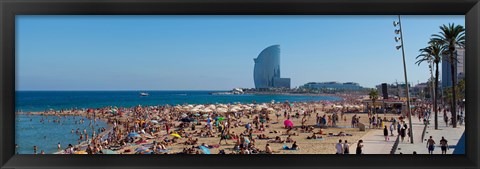 Framed Tourists on the beach with W Barcelona hotel in the background, Barceloneta Beach, Barcelona, Catalonia, Spain Print