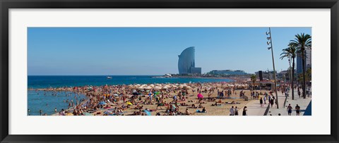 Framed Tourists on the beach with W Barcelona hotel in the background, Barceloneta Beach, Barcelona, Catalonia, Spain Print