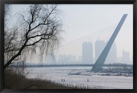 Framed Songhuajiang Highway Bridge over the frozen Songhua River with buildings in the background, Harbin, Heilungkiang Province, China Print