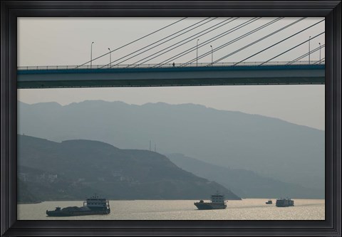 Framed Container ships passing a newly constructed bridge on the Yangtze River, Wanzhou, Chongqing Province, China Print