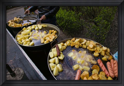 Framed Vendor selling deep fried potatoes and sausages at a sidewalk food stall, Old Town, Dali, Yunnan Province, China Print