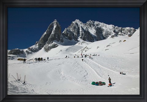 Framed People enjoying snow tubing at Jade Dragon Snow Mountain, Lijiang, Yunnan Province, China Print