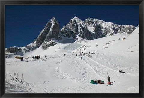 Framed People enjoying snow tubing at Jade Dragon Snow Mountain, Lijiang, Yunnan Province, China Print