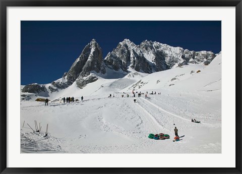 Framed People enjoying snow tubing at Jade Dragon Snow Mountain, Lijiang, Yunnan Province, China Print