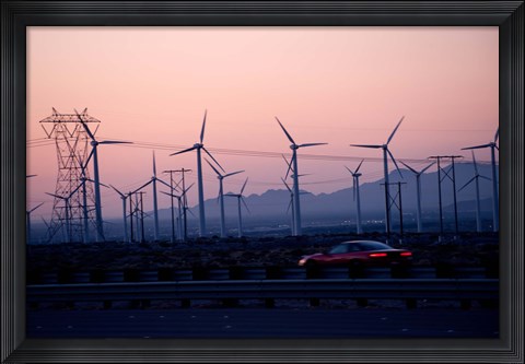 Framed Car moving on a road with wind turbines in background at dusk, Palm Springs, Riverside County, California, USA Print