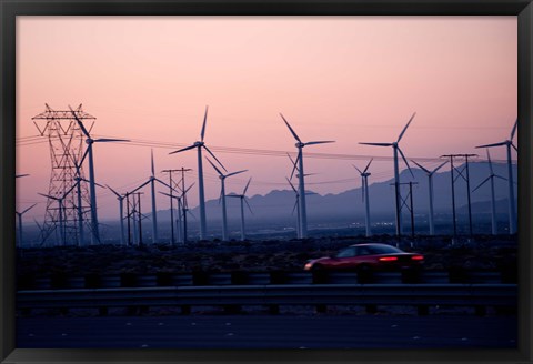 Framed Car moving on a road with wind turbines in background at dusk, Palm Springs, Riverside County, California, USA Print