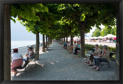 Framed People sitting on benches among trees at lakeshore, Lake Como, Cernobbio, Lombardy, Italy Print