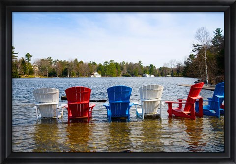 Framed Adirondack chairs partially submerged in the Lake Muskoka, Ontario, Canada Print