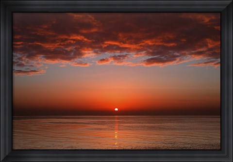 Framed layer of clouds is lit by the rising sun over Rio de la Plata, Buenos Aires, Argentina Print