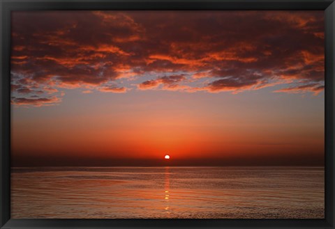 Framed layer of clouds is lit by the rising sun over Rio de la Plata, Buenos Aires, Argentina Print