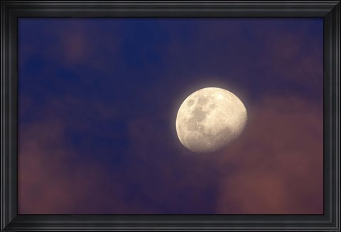 Framed moon between colorful clouds at sunset Print