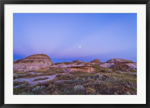 Framed Gibbous moon and crepuscular rays over Dinosaur Provincial Park, Canada Print