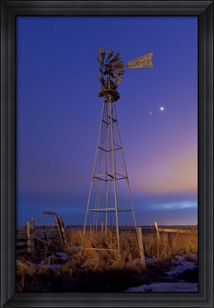 Framed Venus and Jupiter are visible behind an old farm water pump windmill, Alberta, Canada Print
