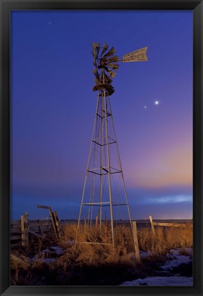 Framed Venus and Jupiter are visible behind an old farm water pump windmill, Alberta, Canada Print