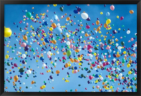 Framed Holiday balloons drifting into the sky Print