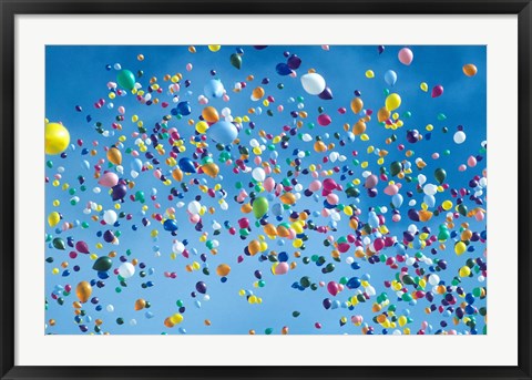 Framed Holiday balloons drifting into the sky Print