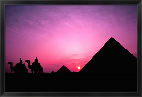 Framed Colorful Sunset Silhouetting Men and Camels at the Great Pyramids of Giza, Egypt Print