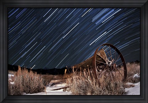 Framed Abandoned farm equipment against a backdrop of star trails Print