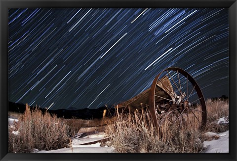 Framed Abandoned farm equipment against a backdrop of star trails Print