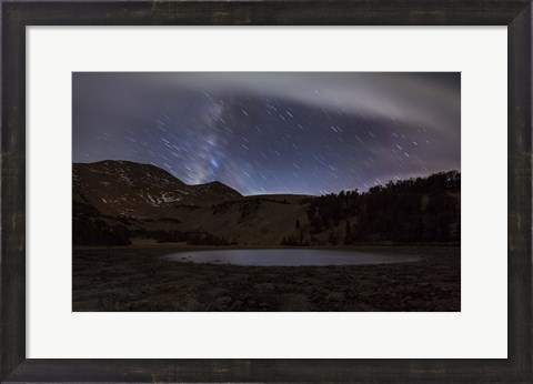 Framed Star trails and the blurred band of the Milky Way above a lake in the Eastern Sierra Nevada Print