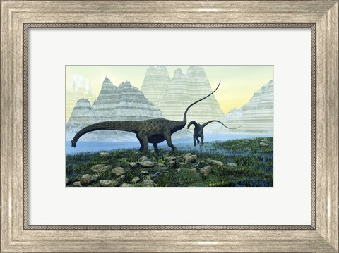 Framed Diplodocus dinosaurs munch on vegetation near a mountain lake Print