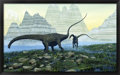 Framed Diplodocus dinosaurs munch on vegetation near a mountain lake Print