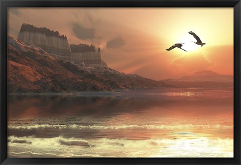 Framed Two Bald Eagles fly along a mountainous coastline at sunset Print