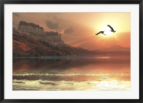 Framed Two Bald Eagles fly along a mountainous coastline at sunset Print